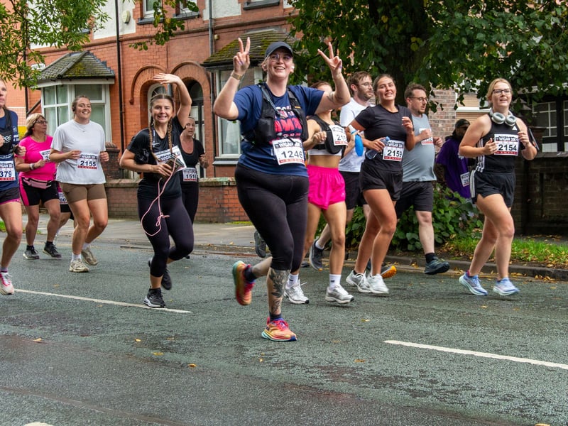 Runners wave and smile to the crowd. Picture: AM Standish