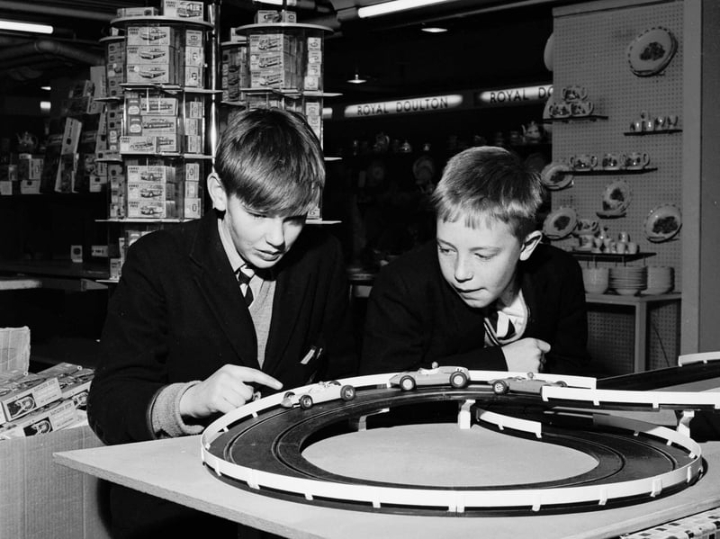 Schoolboys playing with a slot-car racing set called Trix in the toy department of Binns Department Store in November 1965.