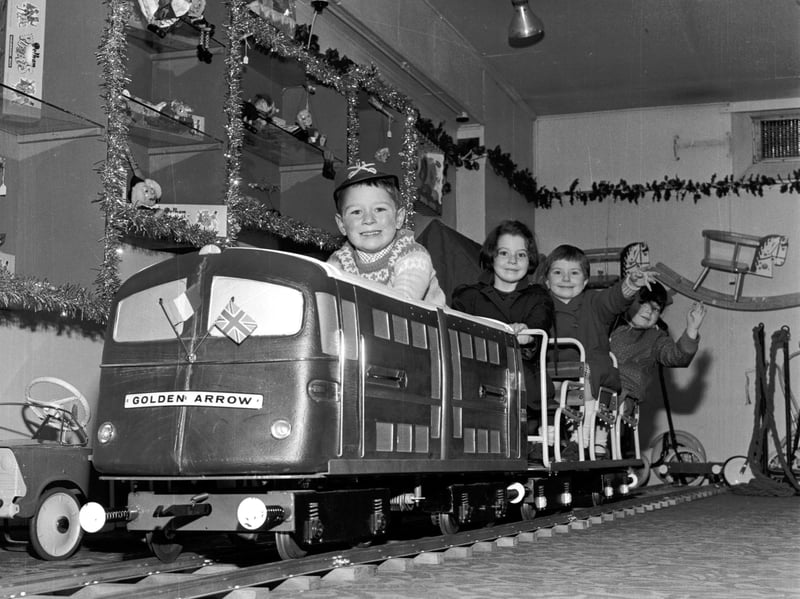 Children play on the model of the Golden Arrow engine in Jenners in November 1965.