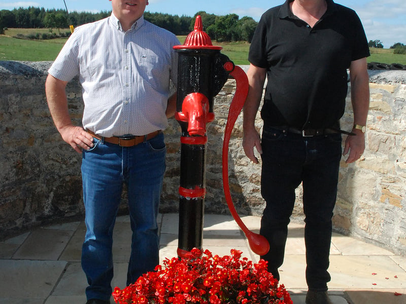 Seamus Ryan and Tony Flannery by the beautifully preserved parish pump in Knock village. Photo: PJ Wright