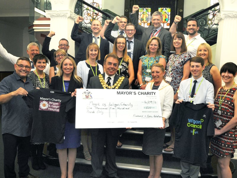Wigan Council staff who took part in the Wigan 10k present a £1,500 cheque to mayor Coun Ron Conway and mayoress Janet Conway for Wigan and Leigh Hospice
