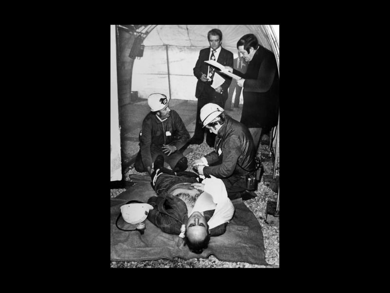 Judges watch intently to mark every move as miners test first aid skills on a "casualty" at Cannock in November 1976. Some colliery teams travelled long distances to take part in an NCB Western Area First Aid League "match." They used this replica of a mine gallery and other props to give the tests an authentic atmosphere. 