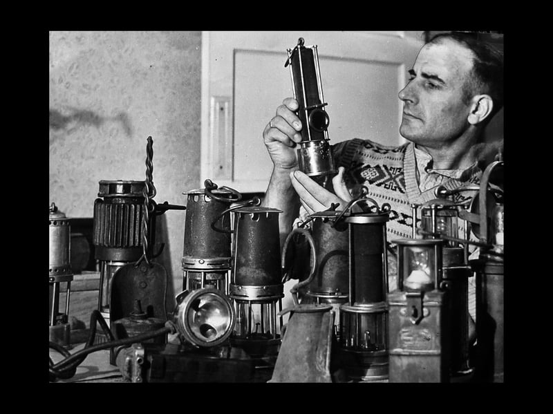 Cannock miner Bert Pritchard had a collection of miners' lamps, which included one over a century old, and another of a type in use for nearly 200 years. The picture is from 1955.