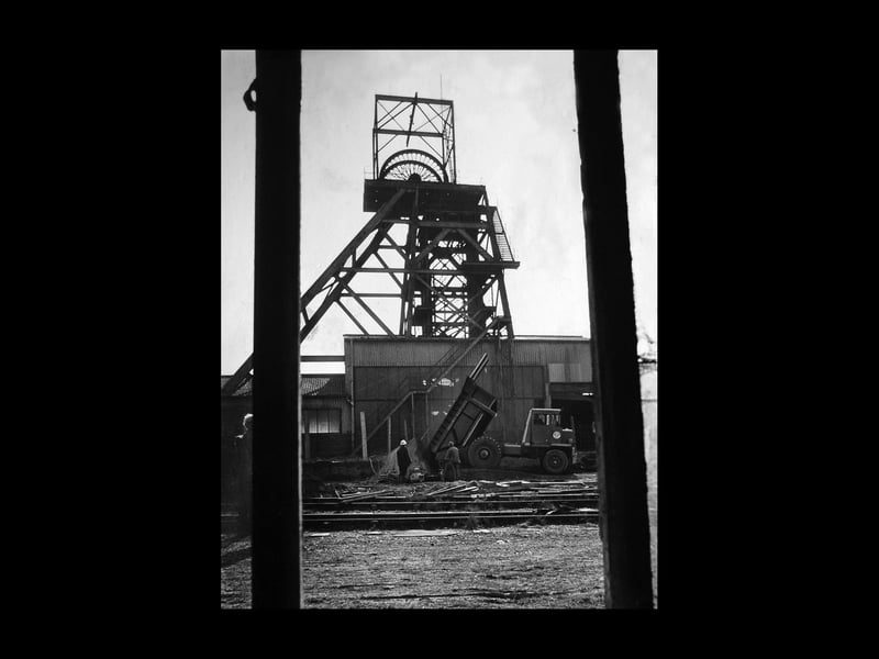 The original caption to this April 1974 picture was: "Many of Britain's 100,000 mine shafts were never properly filled in. But today the Coal Board works like a good dentist to fill the cavities. At Cannock Wood Colliery, which closed last year, three shafts are getting 25,000 tons of hardcore and hard durable caps... The work is done by the West Midland area shaft team led by specialist engineer Reg Thorneycroft and senior overman Joe Bishop, who once worked at the 'Wood' as a safety officer..."