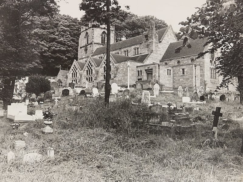 Long grass and wild growth surround the headstones in the front churchyard of St Michael and All Angels in Tettenhall during July 1969. Captured before the extensive tidy-up effort was fully underway, the wide shot showcases the grand stone architecture of the historic parish church framed by dense summer foliage. The site remains a cherished landmark on the outskirts of Wolverhampton, rich with centuries of local community history. Do you remember how Tettenhall Church looked before the grounds were cleared back in the summer of 1969?