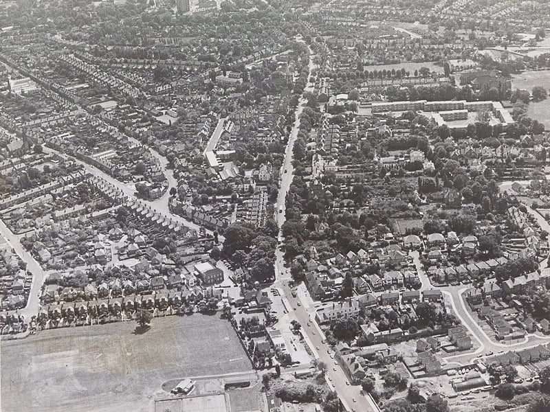 Captured from high above in July 1969, this sweeping aerial view reveals the sprawling suburban layout of the Newbridge area of Wolverhampton. Tettenhall Road cuts vertically through the centre of the image, flanked by Newbridge playing field in the bottom left corner and surrounding residential avenues including Crowther Road and Newbridge Crescent. The fascinating perspective highlights how the leafy western suburbs developed alongside major connecting routes leading out of the town centre. Do you recognise your own house or neighbourhood in this 1969 aerial photograph of Newbridge?