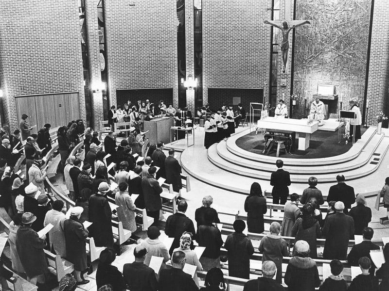 Worshippers fill the circular nave of St Michael's Catholic Church on Coalway Road in May 1969 for a special service set to a contemporary acoustic accompaniment. Organised by members of the Young Christian Workers as part of the Feast of St Joseph celebrations, the Mass featured hymns sung against a folk music background. The scene reflects the changing liturgical traditions of the late 1960s, as local parishes across Wolverhampton embraced modern musical styles to engage younger congregations within their newly constructed places of worship. Do you remember attending services at St Michael's Church on Coalway Road or taking part in folk Mass celebrations during the late 1960s?