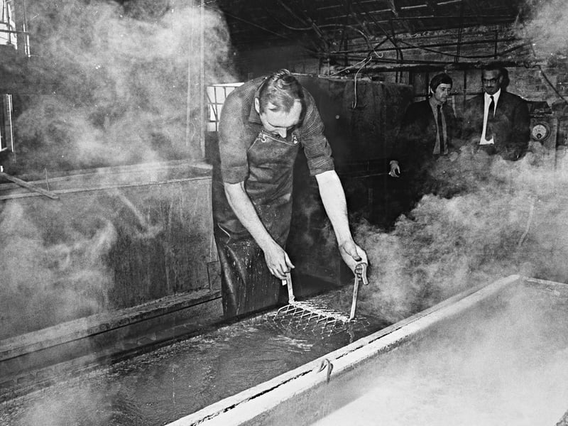 Enveloped in clouds of steam, a worker carefully dips metal components into chemical baths at James Gibbons Ltd in October 1969. The scene captures the final days of the factory's old hand-operated anodising plant before it was decommissioned and sent to the scrapyard to make way for modern automated facilities. A historic name in Wolverhampton manufacturing known for high-quality architectural ironmongery and metalwork, the firm’s transition marked another step forward in the technological upgrading of local Black Country industry. Do you or a family member remember working at the James Gibbons foundry or witnessing the changing techniques in Wolverhampton's metal trades?