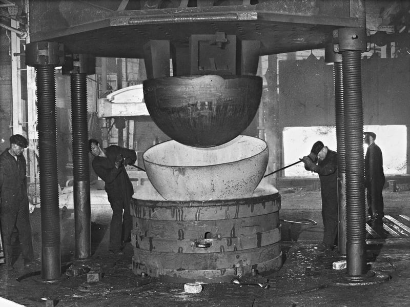 Ironworkers guide a large steel dome as a massive industrial press forms a smooth hemisphere at the Wolverhampton works of the Thompson Horseley Division, part of the John Thompson Group, in May 1969. These heavy steel pressings formed the essential structural components for liquid carbon dioxide storage spheres manufactured by the company. Showcasing the region's advanced engineering prowess, an identical hemisphere was selected for display at the International Chemical and Petroleum Exhibition, highlighting Wolverhampton's reputation as a leader in heavy industrial manufacturing. Do you remember working at the Thompson Horseley works or witnessing the heavy industrial manufacturing across Wolverhampton in the 1960s?