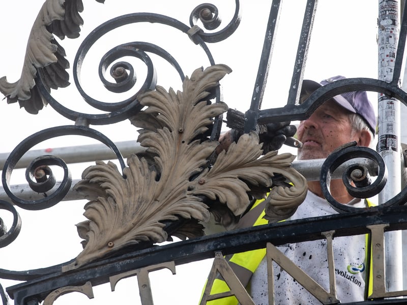 Alan Darlington from Evolution painting the gates at Stanley Park
