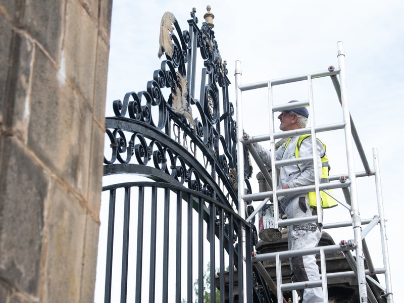 Alan Darlington from Evolution painting the gates at Stanley Park