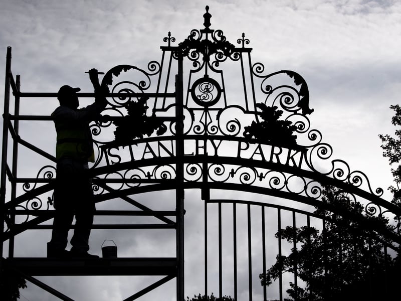 Alan Darlington from Evolution painting the gates at Stanley Park