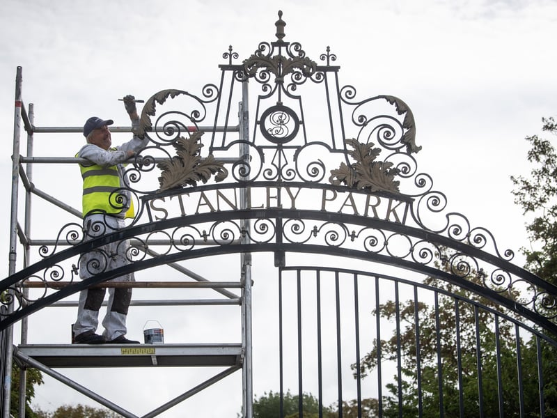 Alan Darlington from Evolution painting the gates at Stanley Park