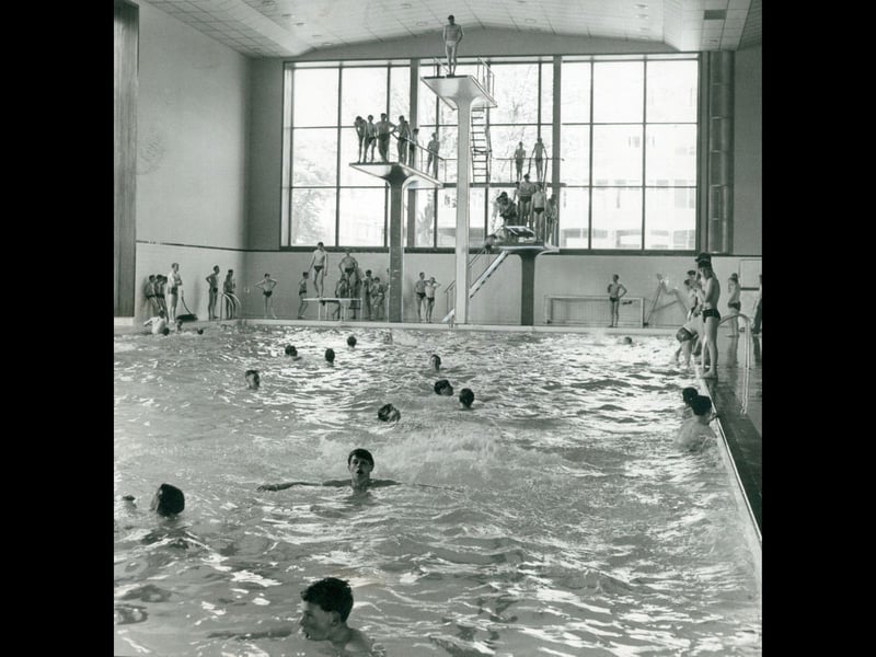 Swimmers pack out the main pool while brave lads queue up for the high board at Walsall Gala Baths in May 1961. The impressive modern facility featured towering diving platforms and massive floor-to-ceiling windows that flooded the hall with natural light. A popular haunt for local schoolchildren, casual paddlers, and daring divers alike, the municipal baths were the place to be for a weekend splash or a formal swimming gala in the early 60s. Did you ever brave the top diving board at Walsall Gala Baths or pop down for a swim in your youth?