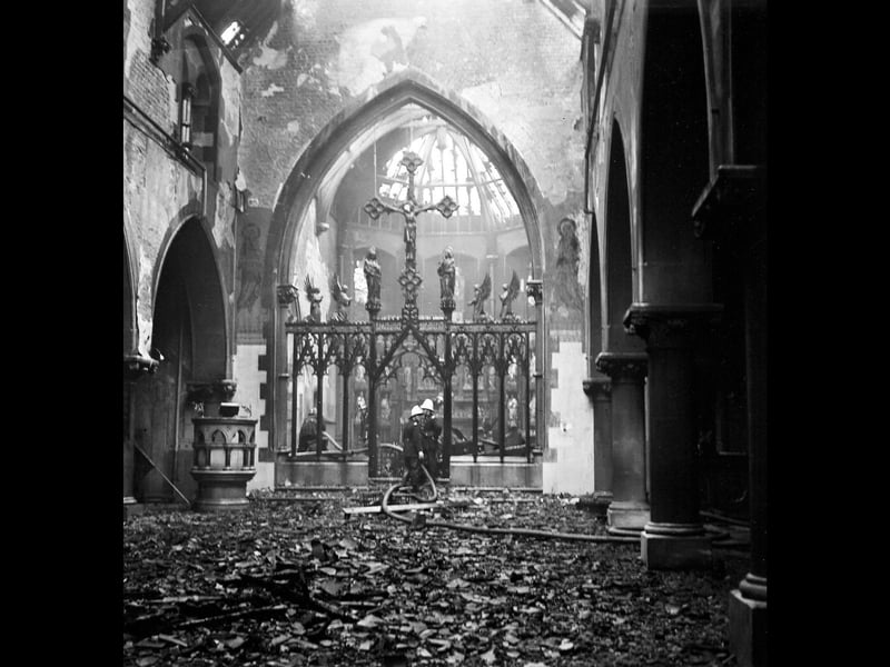 Firefighters survey the charred interior and collapsed roof timbers of St Michael and All Angels Church in Caldmore following a devastating blaze on June 6, 1964. Remarkably, amidst the blackened rubble and scorched stone arches, the ornate metal rood screen and crucifix remained standing at the chancel step. The sudden destruction of the cherished Victorian parish church sent shockwaves through the local community, serving as a heartbreaking moment in Caldmore's history before rebuilding efforts could eventually take shape. Do you remember the night the parish church was lost to the flames, or the community effort to rebuild afterwards?