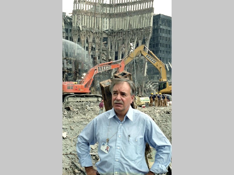 In this particularly haunting image, what remains of the iconic arches that made up the base of the Twin Towers are instantly recognisable behind Paul.