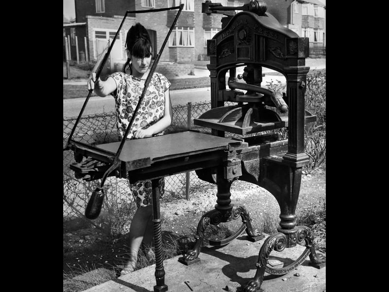 Seventeen-year-old typist Jennifer Cooke poses alongside a 100-year-old antique printing press displayed outside the works of Deason Limited in Aldridge in May 1965. Having produced proof prints right up until the outbreak of the Second World War, the old flatbed press was eventually superseded by modern cylinder machinery. Saved from the scrapheap, the cast-iron relic was given a place of honour outside the printing firm to serve as a permanent memorial to the early days of the print trade. Do you remember seeing this historic printing press standing on display outside the works in Aldridge?
