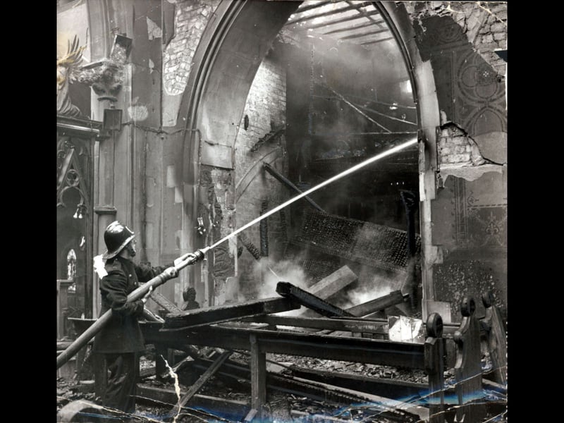 A lone firefighter directs a high-pressure jet of water into the smoking, charred interior of St Michael and All Angels Church in 1964. Surrounded by fallen timber beams, scorched stonework, and peeling wall stencils, emergency crews worked tirelessly to douse remaining hotspots after a fierce blaze swept through the Victorian place of worship. The tragic destruction deeply shocked the Caldmore community, leaving a stark scene of ruin inside one of Walsall's most familiar parish landmarks. Do you remember seeing the emergency services at the scene on the day of the fire?