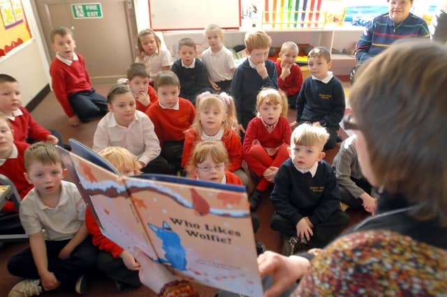 Look at the fascination on the faces of these youngsters as they enjoy a reading session at the school.