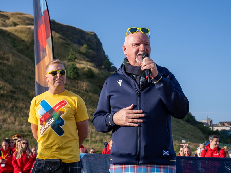 Olympic hero Sir Chris Hoy looks on as philanthropist Sir Tom Hunter delivers a speech.
