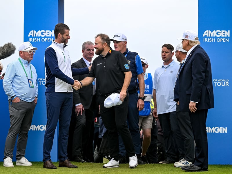 Shane Lowry  shakes hands with Executive Vice President of the Trump Organisation Eric Trump, left, as U.S. President Donald Trump watches on during day four of the Amgen Irish Open Golf Championship 2026 at Trump International Golf Links in Doonbeg, Clare. 