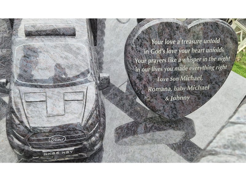 Positioned next to a heartfelt tribute from some of Michael's loved ones is a flatbed truck, etched in marble