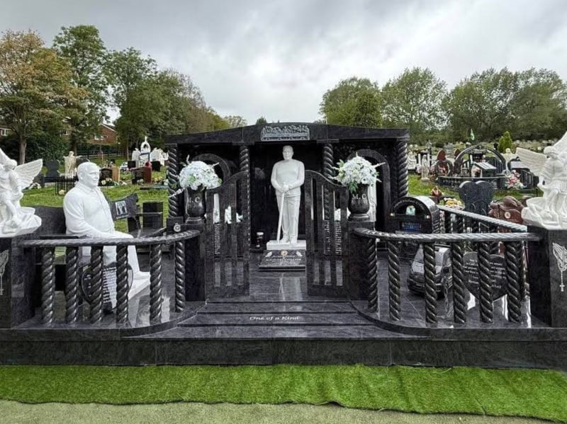 Standing at nine-and-a-half feet tall, the lavish memorial to Michael Collins features two life-like statues of him, along with a marble pint of Guinness, a pint glass bearing the initials “MC” and embossed depictions of a can of Diet Coke and a bottle of Budweiser.