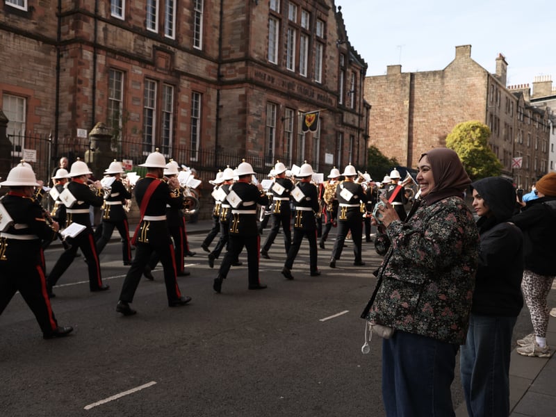Sailors from HMS Queen Elizabeth and the Royal Marine Band march through Edinburgh.