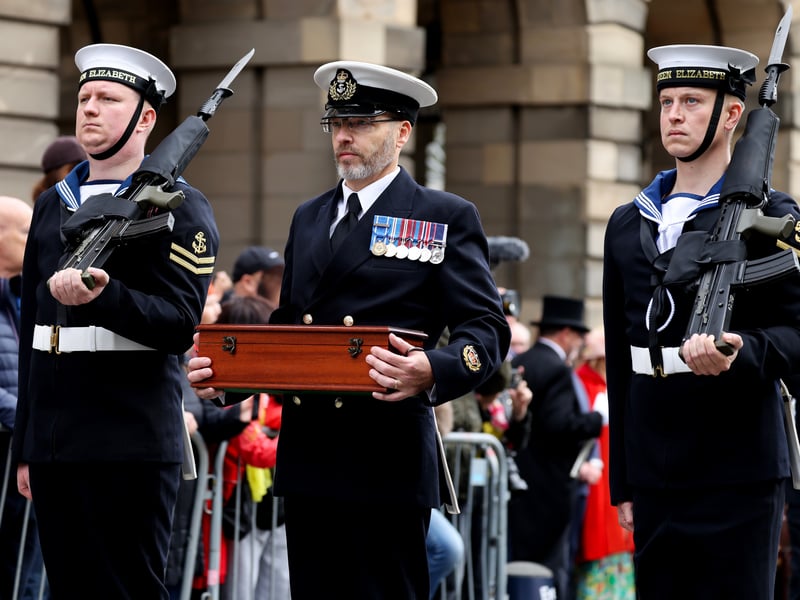 Sailors from HMS Queen Elizabeth and the Royal Marine Band march through Edinburgh.