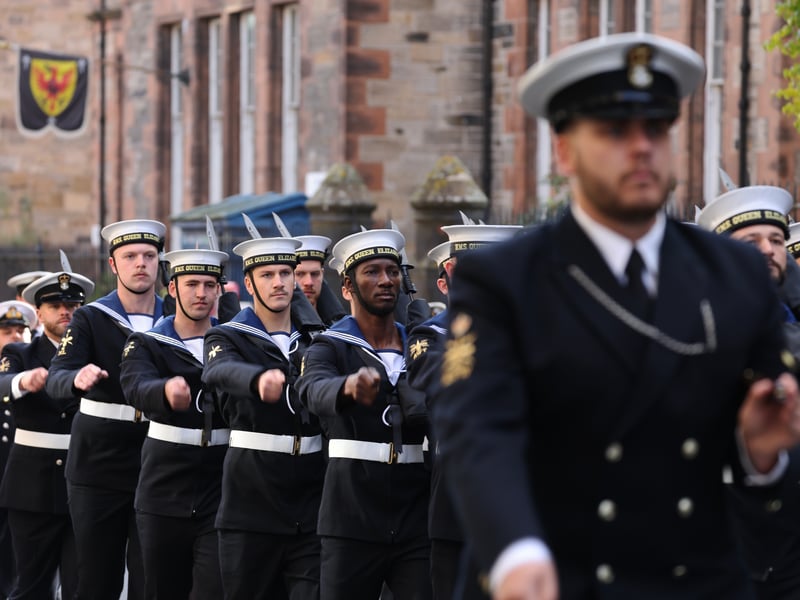 Sailors from HMS Queen Elizabeth and the Royal Marine Band march through Edinburgh.