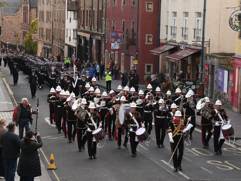Sailors from HMS Queen Elizabeth and the Royal Marine Band march through Edinburgh.