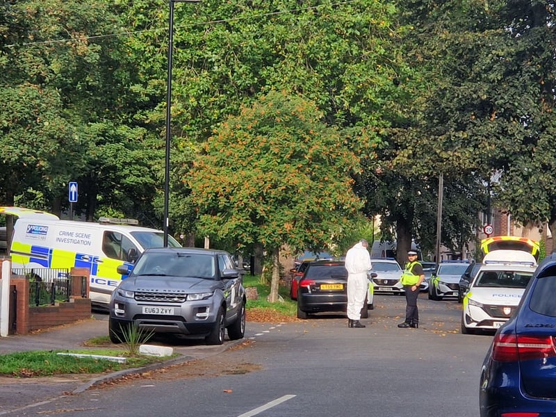 Officers in white overalls at the police incident on Horninglow Road. Photo: Finn Smith, Iconic Media