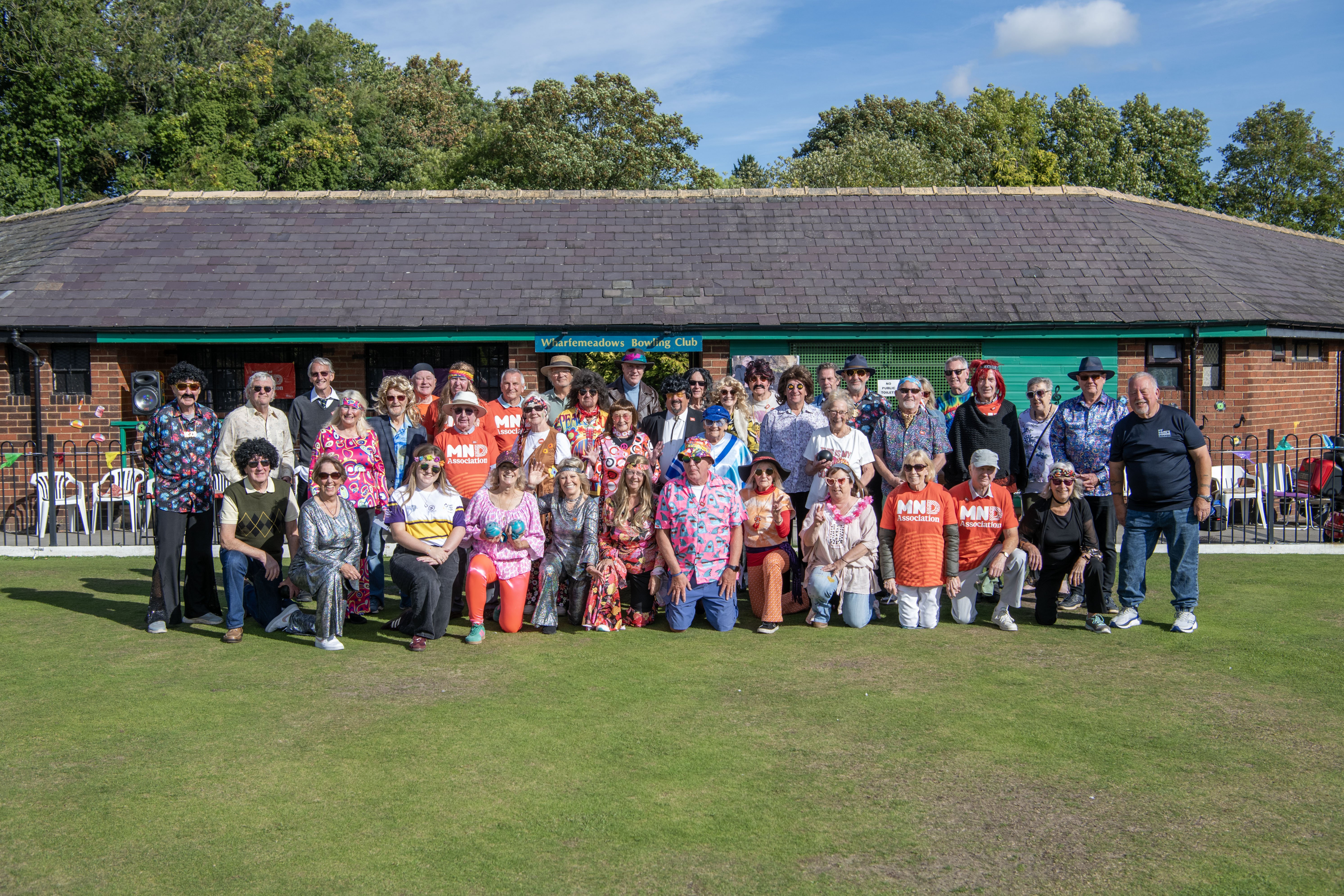 Members in period costumes for the Wharfemeadows Bowling Club charity game to raise money for the Rob Burrow Centre for MND, with a 1970s theme.