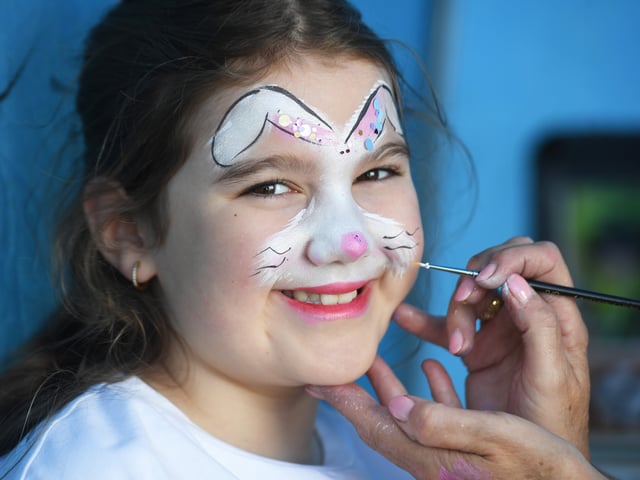 9=year-old Kitty Dalladay has her face painted.