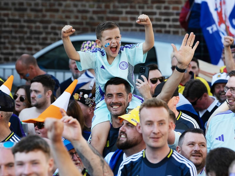 A young Scotland fan with his dad, former Partick Thistle striker Brian Grahan, gets ready to cheer on his team.