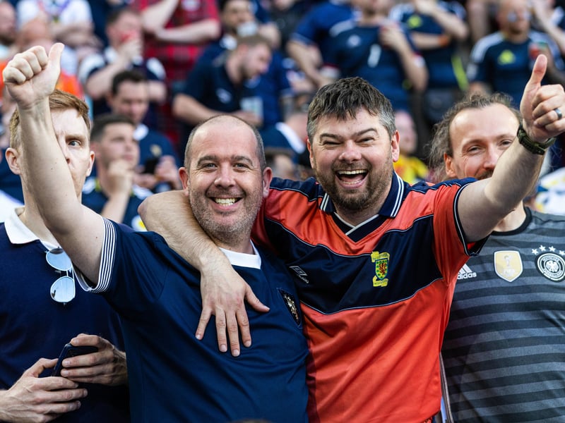 Two Scotland fans are all smiles as they gear up for Scotland vs Switzerland at Euro 2024 in Koln.