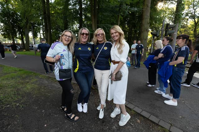 Four Scotland fans prepare for the game with Switzerland at Euro 2024.