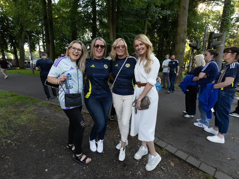 Four Scotland fans prepare for the game with Switzerland at Euro 2024.