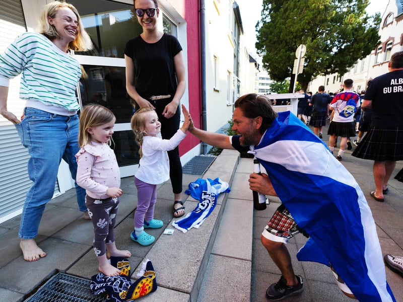 Scotland fans make friends with the locals in Koln, Germany.