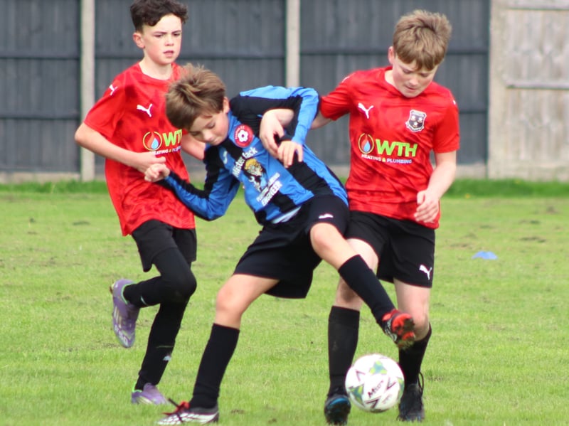 Action from Freckleton Under-11s (in red) v Poulton Blacks