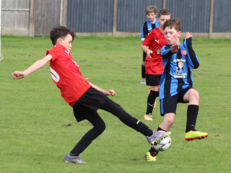 Action from Freckleton Under-11s (in red) v Poulton Blacks