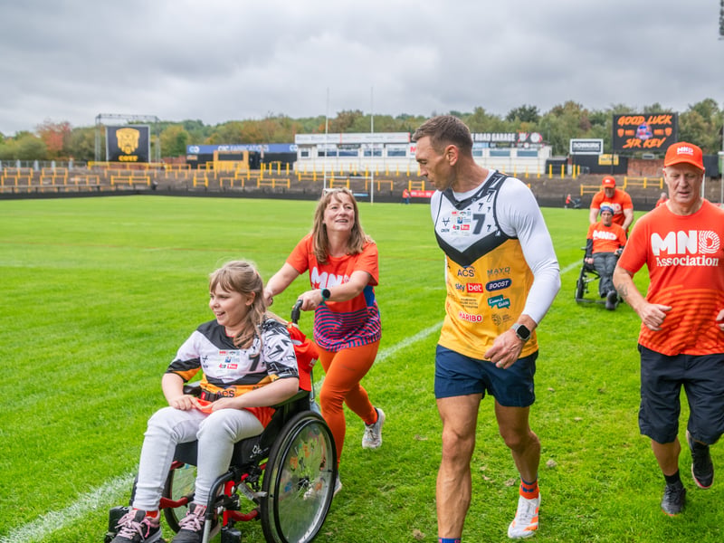Pictured Sir Kevin Sinfield walking the extra mile alongside Inara Quayle, aged 10, from Leeds, and her mum Cheryl Harford.