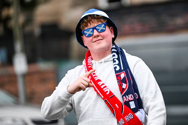 A young Scotland fan with saltire sunglasses ahead of kick-off.