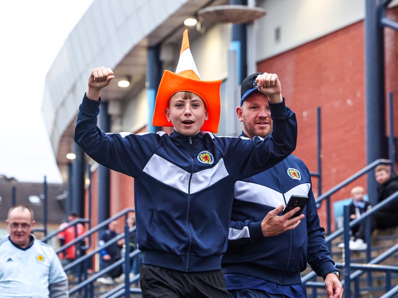 A young Scotland fan dons an orange cone hat ahead of kick-off.