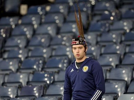 A young Scotland fan makes his way to his seat.