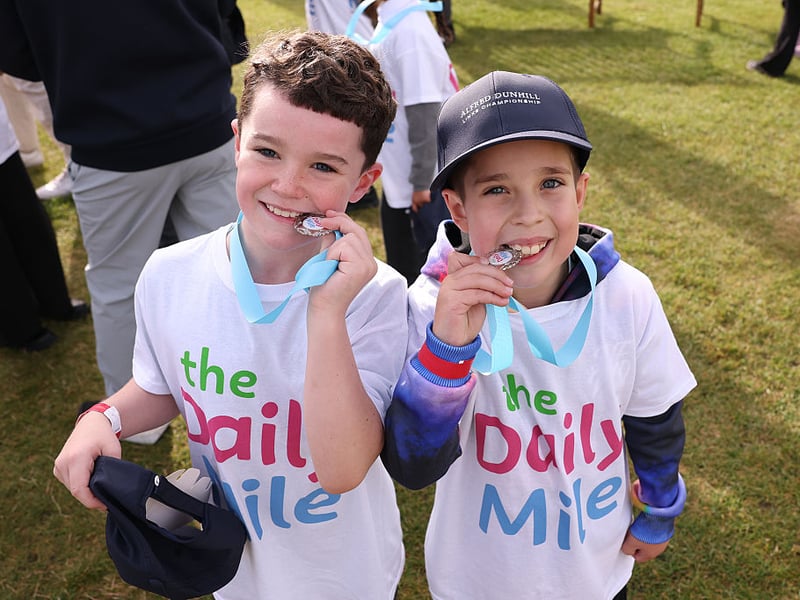 Two children showing off their Daily Mile medals.