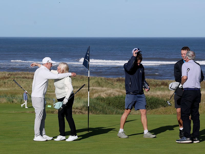 English golfer Matt Fitzpatrick embraces his mum Susan on the green.