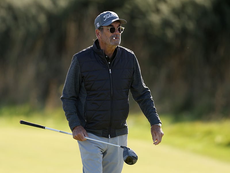 Rock star Huey Lewis carrying his driver during a practice round at St Andrews.