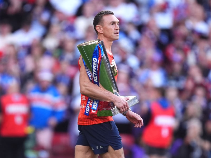 Sir Kev carries the cup in front of thousands of fans.