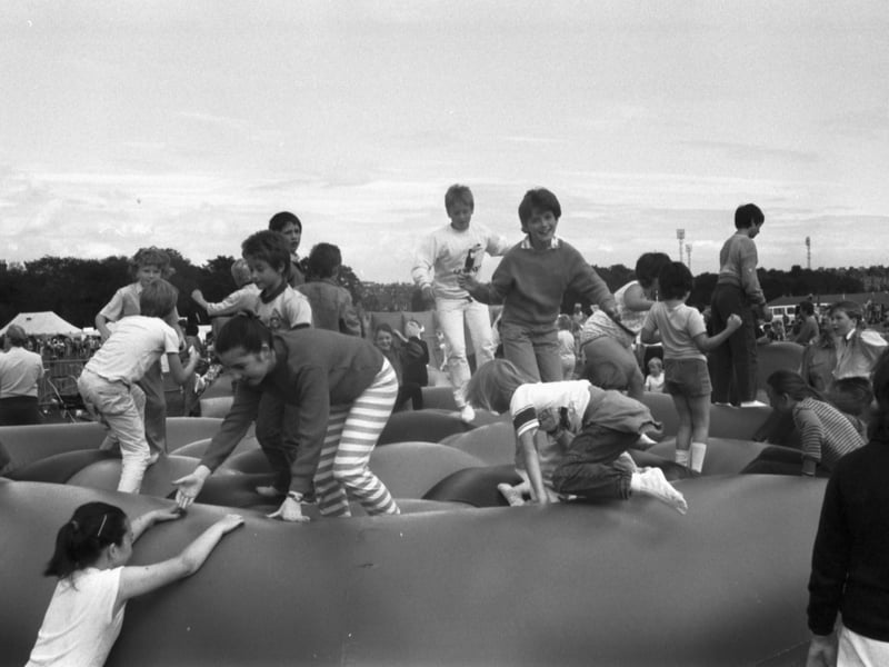 Children playing on a large inflatable on Fringe Sunday in Holyrood Park during the Edinburgh Festival 1986